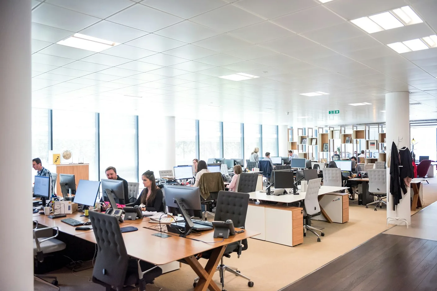 Modern London corporate office with professional team working at computers